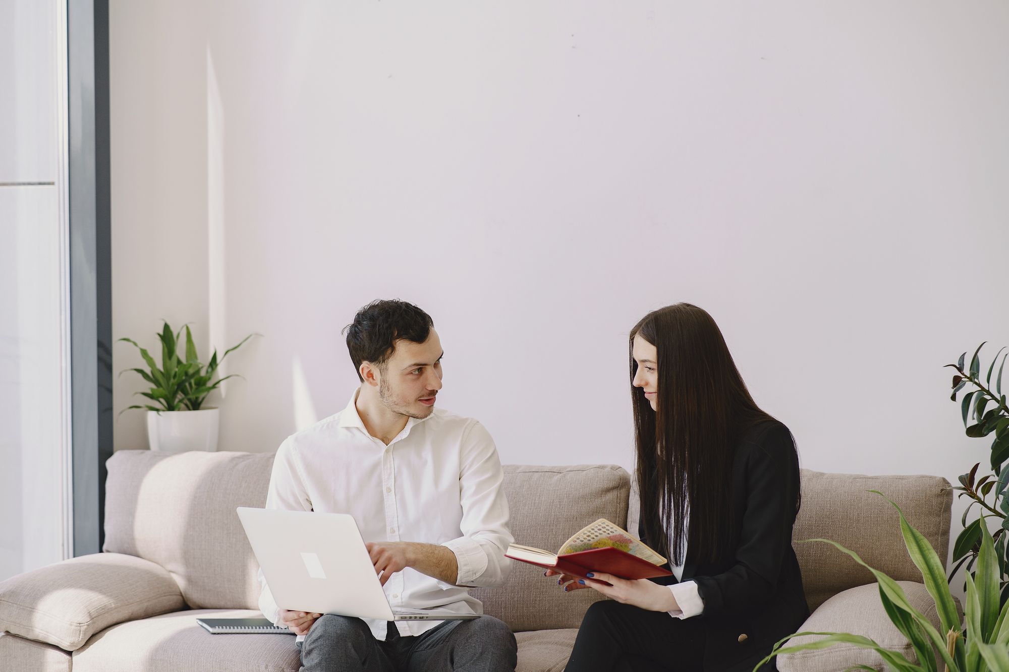 Two colleagues sharing ideas in a naturally lit workspace